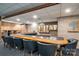 Finished basement bar area with wood paneled accent wall, multiple stools, lighting and a place to serve drinks at 102 3Rd Se Ave, Catawba, NC 28609