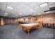 Spacious finished basement area with wood paneling, lighting, billiards table, and bar area for relaxation and entertainment at 102 3Rd Se Ave, Catawba, NC 28609
