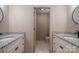 A bathroom features dual vanities with granite tops, tile flooring, and updated fixtures at 102 3Rd Se Ave, Catawba, NC 28609