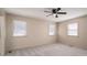A bright bedroom with neutral walls, carpet, and a ceiling fan offers a serene space at 102 3Rd Se Ave, Catawba, NC 28609