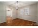 Bright dining room featuring hardwood floors, window with blinds, and modern light fixture at 102 3Rd Se Ave, Catawba, NC 28609