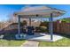 Outdoor gazebo with a gas grill on a concrete patio and brick surrounding wall for privacy and entertainment at 102 3Rd Se Ave, Catawba, NC 28609