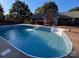 Inviting pool with a waterfall feature, surrounded by a spacious patio and lush greenery at 102 3Rd Se Ave, Catawba, NC 28609