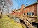 Backyard of brick house featuring a multi-level deck and wooded area at 1146 Crestmont Se Dr, Concord, NC 28025