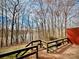 View of lake through the trees from wooden deck with railings at 1146 Crestmont Se Dr, Concord, NC 28025