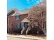 Charming brick townhouse featuring a covered entryway and well-maintained landscaping at 1146 Crestmont Se Dr, Concord, NC 28025
