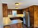 Functional kitchen with wood cabinetry, stainless steel appliances, and a breakfast bar area at 1146 Crestmont Se Dr, Concord, NC 28025