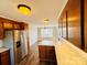 Well lit kitchen with stainless steel refrigerator and granite countertop island at 1146 Crestmont Se Dr, Concord, NC 28025