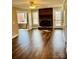 Cozy living room featuring a brick fireplace, hardwood floors, and access to the deck at 1146 Crestmont Se Dr, Concord, NC 28025
