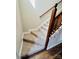 Carpeted stairway with wood railing to the upper level at 1146 Crestmont Se Dr, Concord, NC 28025