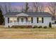 Charming single-story home with a white picket fence and well-maintained front yard at 11918 Crabapple Ln, Huntersville, NC 28078