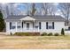 Charming single-story home with a white picket fence and well-maintained front yard at 11918 Crabapple Ln, Huntersville, NC 28078