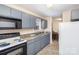 Functional kitchen boasts blue cabinets, modern appliances, and an adjacent dining area at 11918 Crabapple Ln, Huntersville, NC 28078