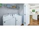 Laundry room with modern washer and dryer units, with the kitchen visible beyond the door at 1348 Secrest Commons Dr, Monroe, NC 28112