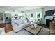 Open-concept living area with modern kitchen, fireplace, and comfortable seating at 1348 Secrest Commons Dr, Monroe, NC 28112