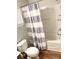 Bathroom features a tub with striped curtain, toilet, and vanity at 140 Marakery Rd # C, Mooresville, NC 28115