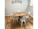 Cozy dining area with stylish wood table, white metal chairs, and neutral wall decor at 140 Marakery Rd # C, Mooresville, NC 28115