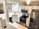Bright kitchen featuring white cabinets, stainless steel appliances, and modern countertops at 140 Marakery Rd # C, Mooresville, NC 28115
