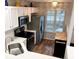 Modern kitchen featuring white cabinets, stainless steel appliances, and a view to the window at 140 Marakery Rd # C, Mooresville, NC 28115