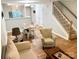 Open living room area with staircase, wood floors, and a dining table at 140 Marakery Rd # C, Mooresville, NC 28115