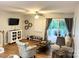 Comfortable living room features wood floors, a ceiling fan, and access to an outdoor deck at 140 Marakery Rd # C, Mooresville, NC 28115