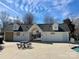 Community pool house with picnic table under a sunny blue sky in a well-maintained community at 140 Marakery Rd # C, Mooresville, NC 28115
