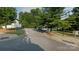 Street view showing parking area with mature trees and street signs at 140 Marakery Rd # C, Mooresville, NC 28115