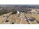 Expansive aerial view of the property showcasing its setting amidst rolling fields and wooded landscape at 147 Stanfield Farm Ln, Stanfield, NC 28163