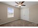 Bedroom features a window with a view of the landscape, closet, and neutral carpet at 147 Stanfield Farm Ln, Stanfield, NC 28163