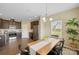 Dining room with wood table and a modern chandelier fixture and backyard views from three windows at 147 Stanfield Farm Ln, Stanfield, NC 28163