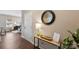 Entryway with wood-look floors, a modern console table with decor, and a round, black mirror at 147 Stanfield Farm Ln, Stanfield, NC 28163