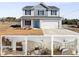 Two story home with grey and white siding, shutters, a blue front door, and a two car garage at 147 Stanfield Farm Ln, Stanfield, NC 28163