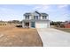 This two-story home features light gray siding and a blue front door at 147 Stanfield Farm Ln, Stanfield, NC 28163