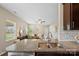 Open-concept kitchen with granite countertops overlooking living room, and white subway tile backsplash at 147 Stanfield Farm Ln, Stanfield, NC 28163