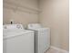 This is a simple laundry room, with a washer, dryer, and a wire rack shelf for storage at 147 Stanfield Farm Ln, Stanfield, NC 28163