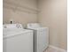 Bright laundry room with washer, dryer and wire shelving for storage at 147 Stanfield Farm Ln, Stanfield, NC 28163