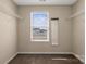 Walk-in closet with shelving, window, and view of the neighborhood landscape at 147 Stanfield Farm Ln, Stanfield, NC 28163