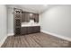 Stylish bar area with a wine rack, cabinetry, sink, countertop, and wooden floors at 154 Fox Hunt Dr, Mooresville, NC 28117