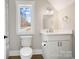 Bright bathroom with a white vanity, modern fixtures, and a window providing natural light at 154 Fox Hunt Dr, Mooresville, NC 28117