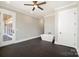 Bright bathroom with a modern tub, ceiling fan, neutral walls, and dark floors at 154 Fox Hunt Dr, Mooresville, NC 28117