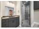 Bathroom featuring a dark vanity with stone countertops, mirror, and glass shower with a bench at 154 Fox Hunt Dr, Mooresville, NC 28117
