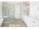 Spacious bathroom featuring a glass shower enclosure, a long vanity with double sinks, and modern lighting at 154 Fox Hunt Dr, Mooresville, NC 28117
