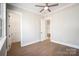 Spacious bedroom with a ceiling fan and natural light, adjacent to a walk-in closet for ample storage at 154 Fox Hunt Dr, Mooresville, NC 28117