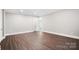 Minimalist bedroom with neutral walls, modern flooring, and a door to another room at 154 Fox Hunt Dr, Mooresville, NC 28117