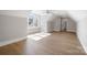 Spacious bedroom featuring light hardwood floors, a modern ceiling fan, and abundant natural light at 154 Fox Hunt Dr, Mooresville, NC 28117