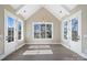 Bright dining room with cathedral ceiling, wood floors, and large windows offering a scenic view at 154 Fox Hunt Dr, Mooresville, NC 28117