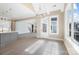 Open-concept dining area featuring wood floors, modern chandelier, and seamless flow into the kitchen at 154 Fox Hunt Dr, Mooresville, NC 28117