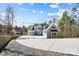 View of the gray, two-story home featuring a three-car garage and concrete driveway leading to the home at 154 Fox Hunt Dr, Mooresville, NC 28117