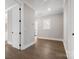Hallway with hardwood flooring, white trim and access to other rooms at 154 Fox Hunt Dr, Mooresville, NC 28117