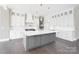 Spacious kitchen with a large gray island, white cabinetry, and stainless steel appliances at 154 Fox Hunt Dr, Mooresville, NC 28117